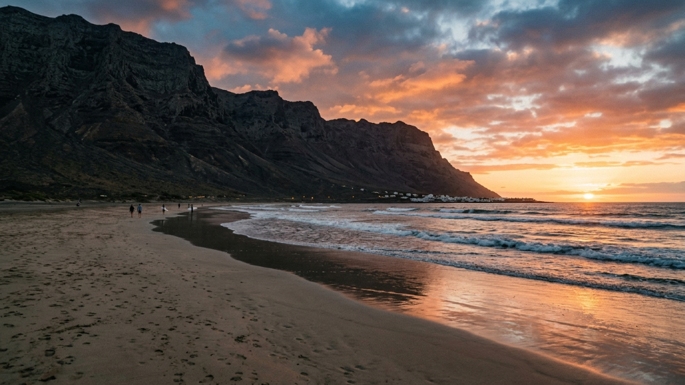 Orange sunset over the Famara cliffs and beach in Lanzarote