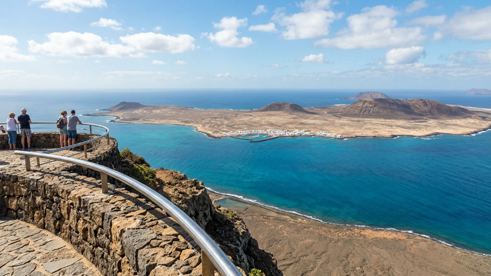 Tourists admire La Graciosa island from the Mirador del Río viewpoint